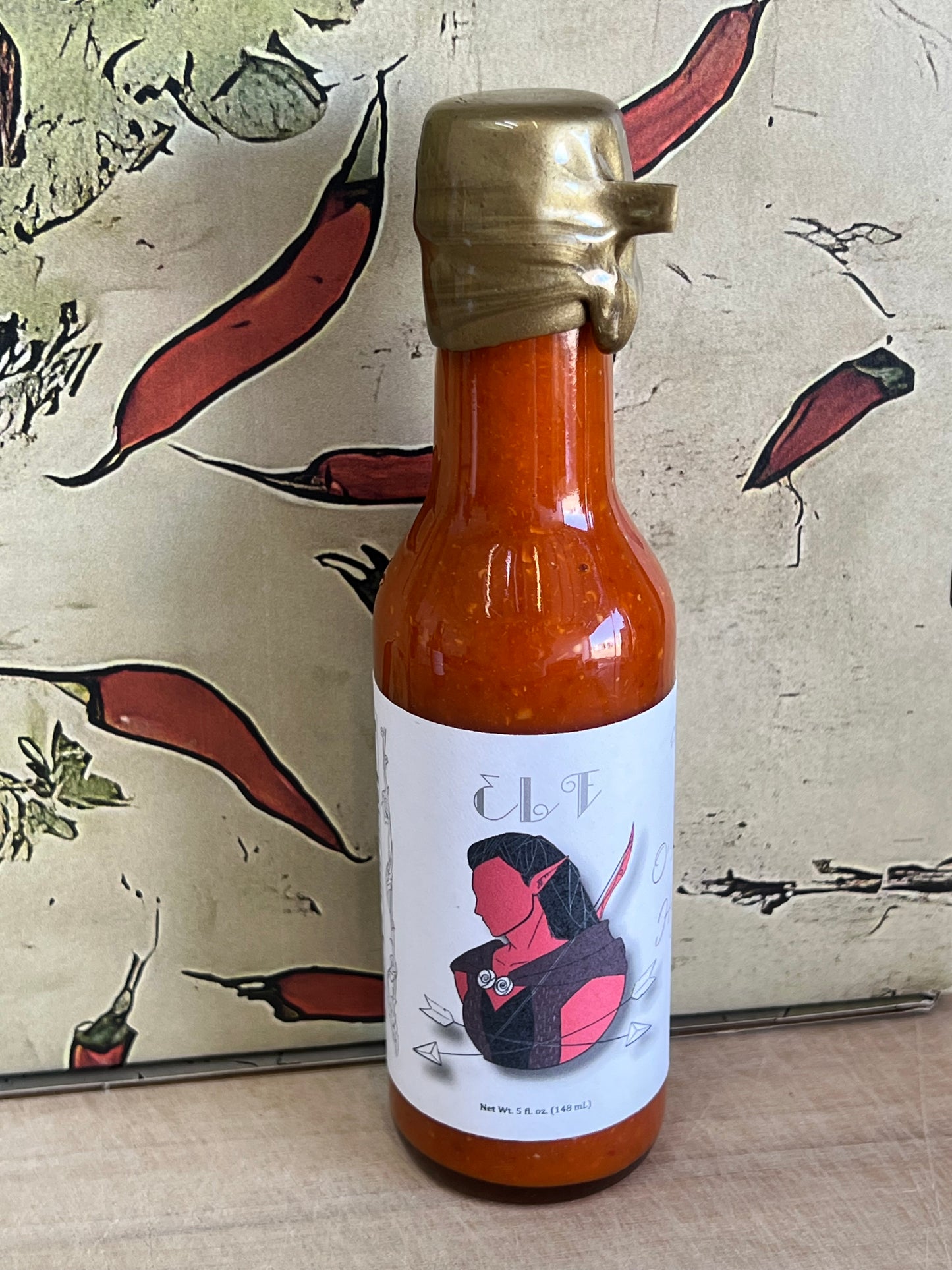 Bottle of lemongrass and ginger sauce by O'Malley's with a bright, citrusy label